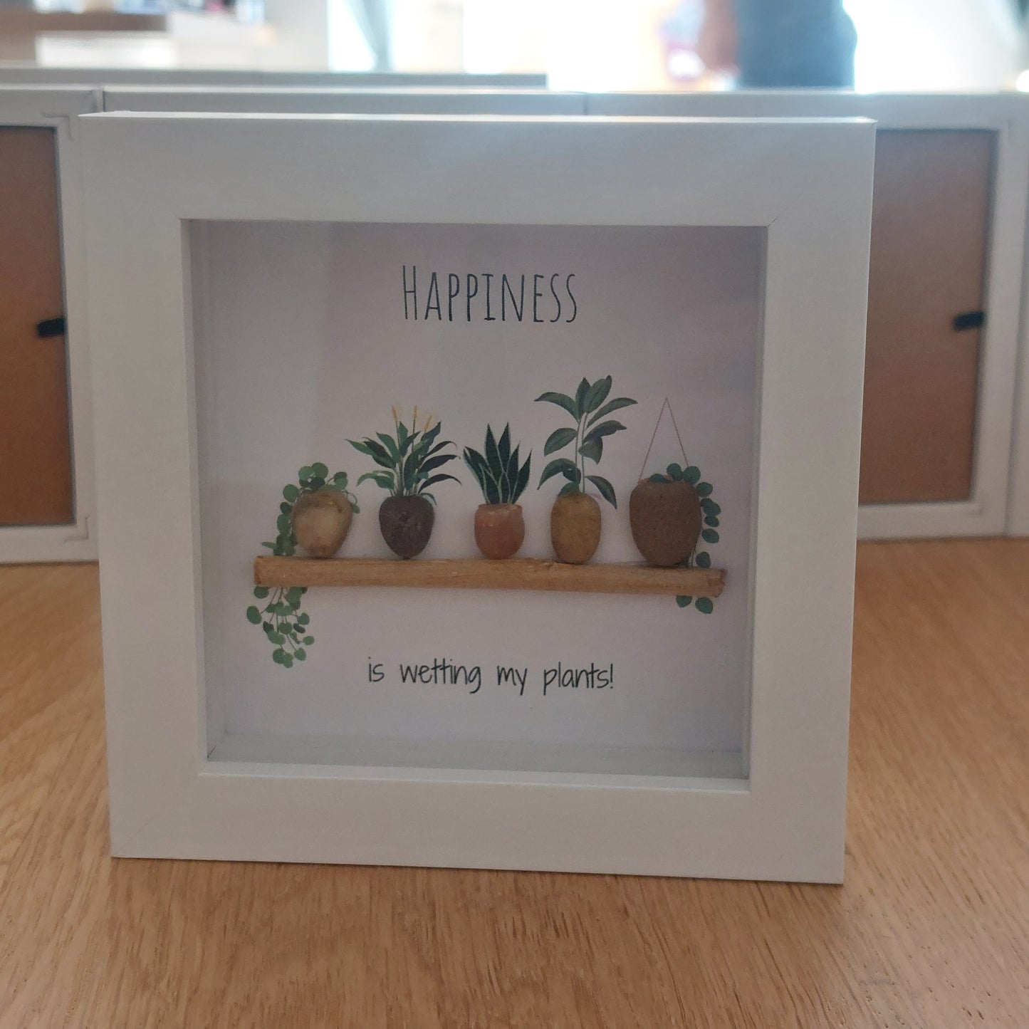 Wetting My Plants - Framed Pebble Art