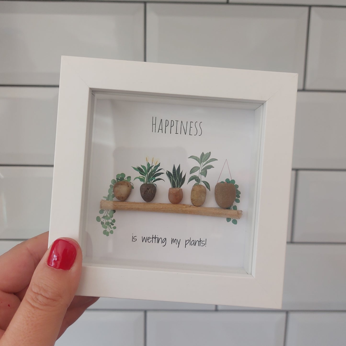 Wetting My Plants - Framed Pebble Art